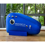 A blue Macy-Pan Hyperbaric Oxygen Therapy Chamber sitting type with visible pressure control valves and a logo on the side, placed in a room with a large window.