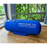 Blue hyperbaric oxygen chamber labeled 'Macy-Pan 901' in a room with large windows.